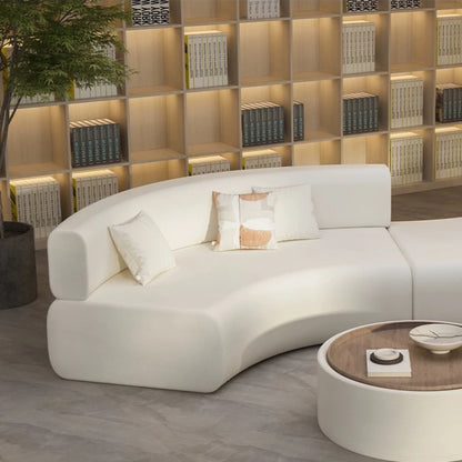canape courbe blanc avec accoudoirs et coussins