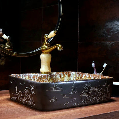 lavabo rectangulaire noir gravures dorees robinet dore