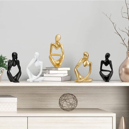 sculpture abstraite noire blanche doree personnages assis decoration