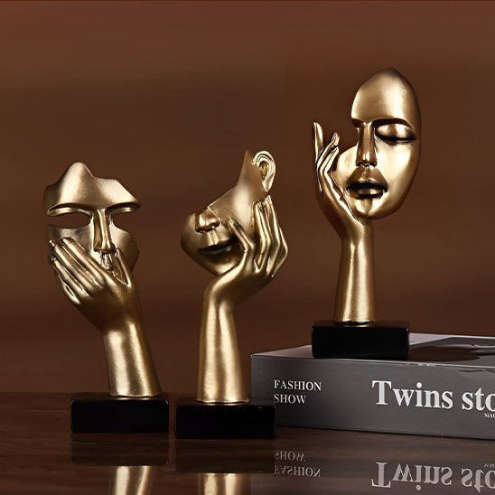 sculpture visage abstrait dore trois pieces
